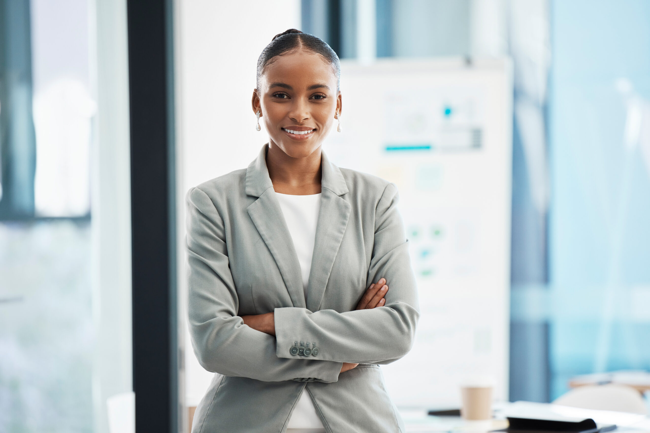 Professional, corporate businesswoman with arms crossed, in position of leadership, in marketing st.