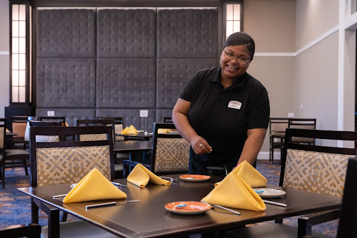 Server setting the table at Masonic Homes Kentucky