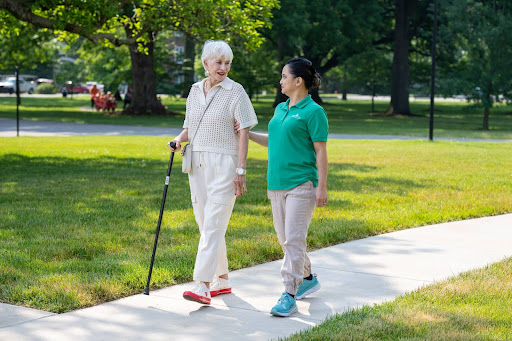 Senior walking with Masonic Homes Kentucky Caregiver