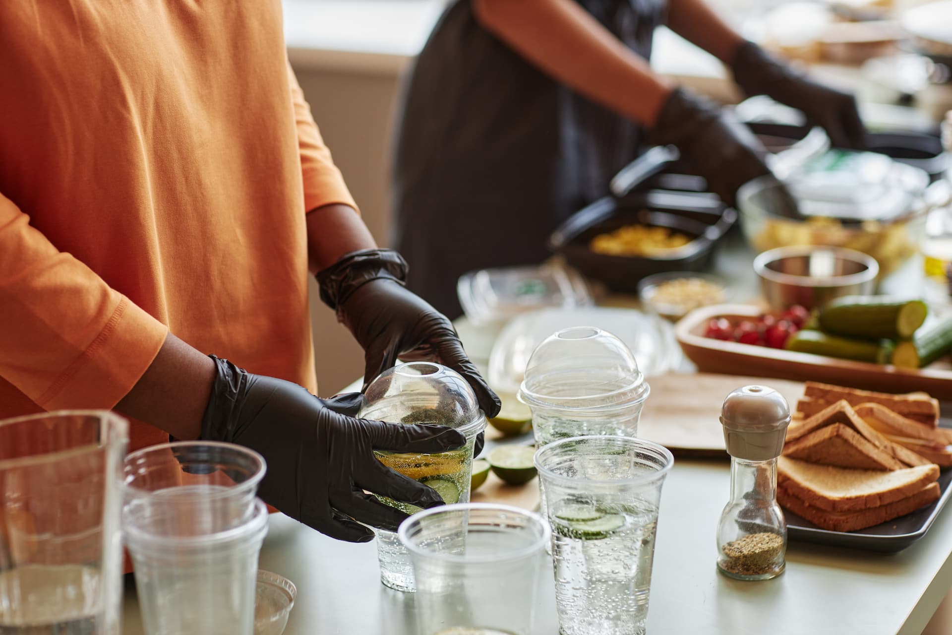 Dining team members preparing food and drinks for residents at a senior living community.